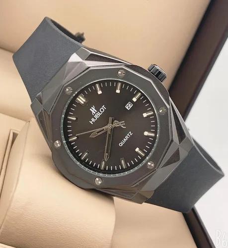 Hublot watch with black face and gray strap on a neutral background